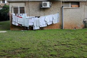 Washed laundry hangs on a rope outside the window. photo