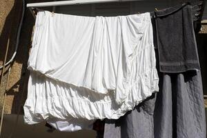 Washed laundry hangs on a rope outside the window. photo