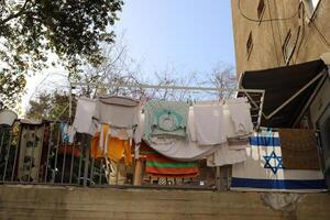 Washed laundry hangs on a rope outside the window. photo