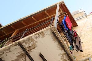 Washed laundry hangs on a rope outside the window. photo