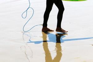 An athlete walks barefoot on the sand on the seashore. photo