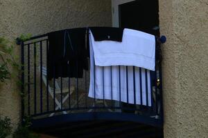 Washed laundry hangs on a rope outside the window. photo