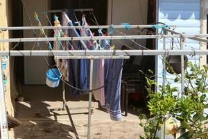 Washed laundry hangs on a rope outside the window. photo