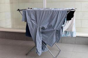 Washed laundry hangs on a rope outside the window. photo