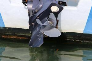 The propeller of a motor boat at the pier in the seaport. photo
