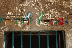 Washed laundry hangs on a rope outside the window. photo