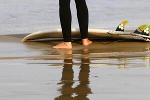 An athlete walks barefoot on the sand on the seashore. photo