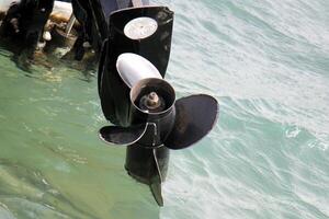 The propeller of a motor boat at the pier in the seaport. photo