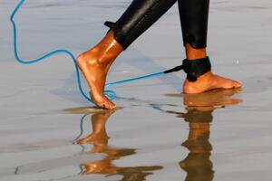 An athlete walks barefoot on the sand on the seashore. photo