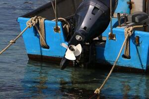 The propeller of a motor boat at the pier in the seaport. photo