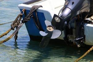 The propeller of a motor boat at the pier in the seaport. photo