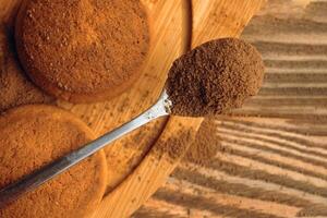 A pile of cookies and a spoonful of cocoa. Macro photo