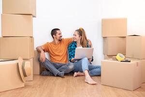 Household Move. Attractive couple with moving boxes becoming independent and opening a new home. photo