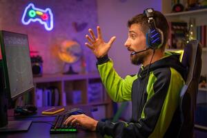Gamer Playing Online Game on Computer with Colorful Neon Led Lights. photo