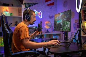Professional Gamer Streaming and Playing Online Game on Computer Colorful Neon Led Lights. photo
