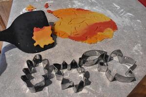 Cookie Cutters Shaped like Leaves and Dough for Fall Leaf Cookies photo