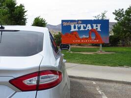 Utah Road Trip, Silver Sedan by Welcome to Utah Sign photo