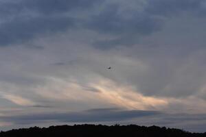 Clouds Building at Sunset in Bronx, New York, One Airplane in the Sky photo