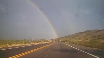 Double Rainbow Seen while Driving on Highway photo