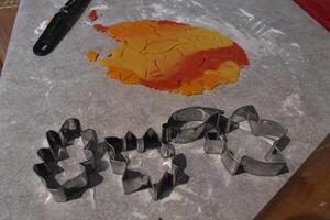4 Cookie Cutters Shaped like Leaves and Dough for Fall Leaf Cookies photo