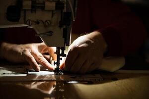 Sewing machine and men's hands of a tailor photo