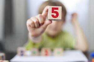 Young Child Learning Mathematics with Number Blocks photo