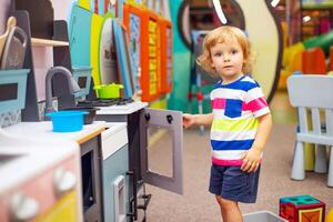 Child playing with colorful toys at the learning center or in kindergarten photo