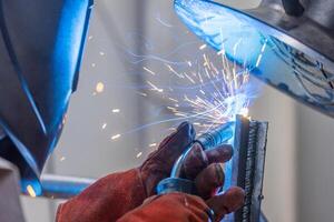 Detail to welding process of metal parts, using a welding machine, bright sparks and flashes, industrial concept photo