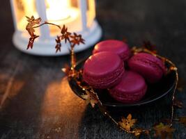 Macaroons and lantern moody food background. High quality photo