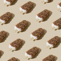 Trendy sunlight chocolate glazed ice cream popsicle pattern on pastel cream background. Minimal summer concept. Ice cream aesthetic. photo