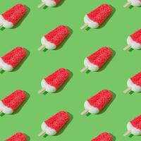 Trendy sunlight red glazed ice cream popsicle pattern on light green background. Minimal summer concept. Ice cream aesthetic. photo
