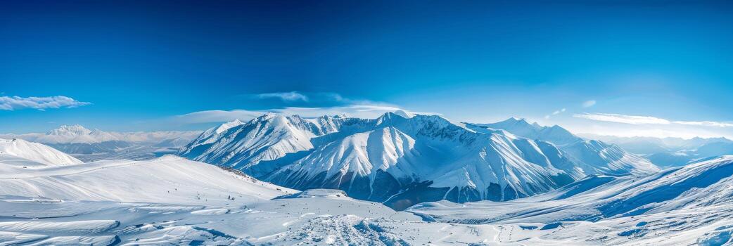 Expansive view of a snow-covered landscape with distant mountains under a bright blue sky. photo