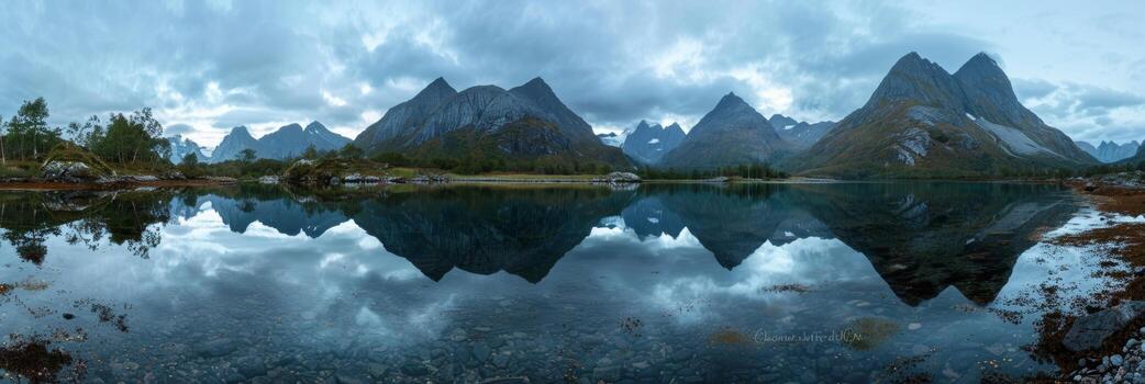 Twilight reflects mountains on a still lake in a tranquil setting. photo