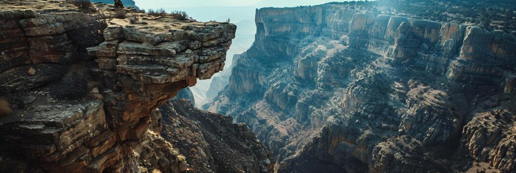 Sunset illuminating the rugged cliffs of a deep canyon with a dramatic sky. photo