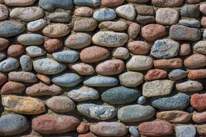wall made of many colorful round stones, full-frame background and texture photo