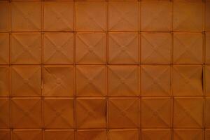 full-frame background and texture of square stamped sheet metal tiles with diagonal ribs photo
