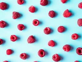 Raspberry pattern, blue background, top view photo