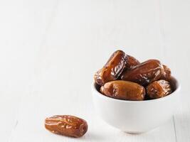 Plate of dried dates on table photo