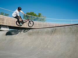 BMX rider performing aerial trick on quarter pipe photo