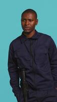 Vertical Anxious security guard shaking head, having trouble following orders during protection job shift. Portrait of troubled bodyguard feeling stressed, having problems at work, studio background, camera B video