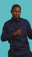 Vertical Security guard standing in fighting stance, prepared to deal with people entering restricted area. Portrait of bodyguard holding defensive pose, ready to throw punches, studio background, camera B video