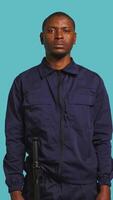 Vertical Security guard tasked with preventing criminal activity and detaining suspects stealing, damaging property, or performing other crimes. Portrait of intimidating bodyguard, studio background, camera B video