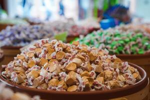 Assorted Wrapped Candies in Market Setting, Close Up View photo