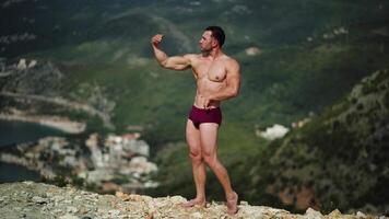 Male athlete beautiful body posing in nature outdor in shorts video
