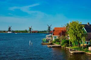 Windmills at Zaanse Schans in Holland on sunset. Zaandam, Netherlands photo