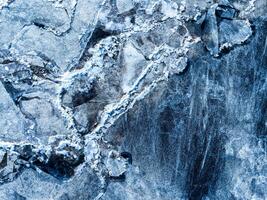 Beautiful view of the frozen river from above. Ice cubes floating on top of the river. photo