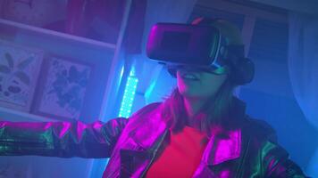 Young woman using virtual reality goggles in the dark room with neon lighting 4K slow motion RED camera. Wireless technologies. video