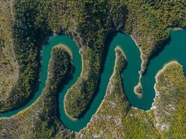 Top view on meanders at rocky river photo