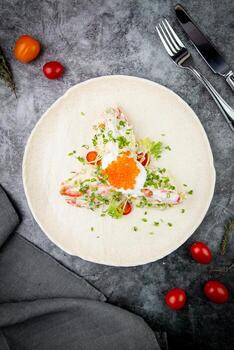 salad with mozzarella, caviar and green onions on a white plate, side view photo