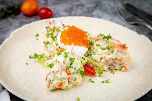 salad with mozzarella, caviar and green onions on a white plate, side view photo